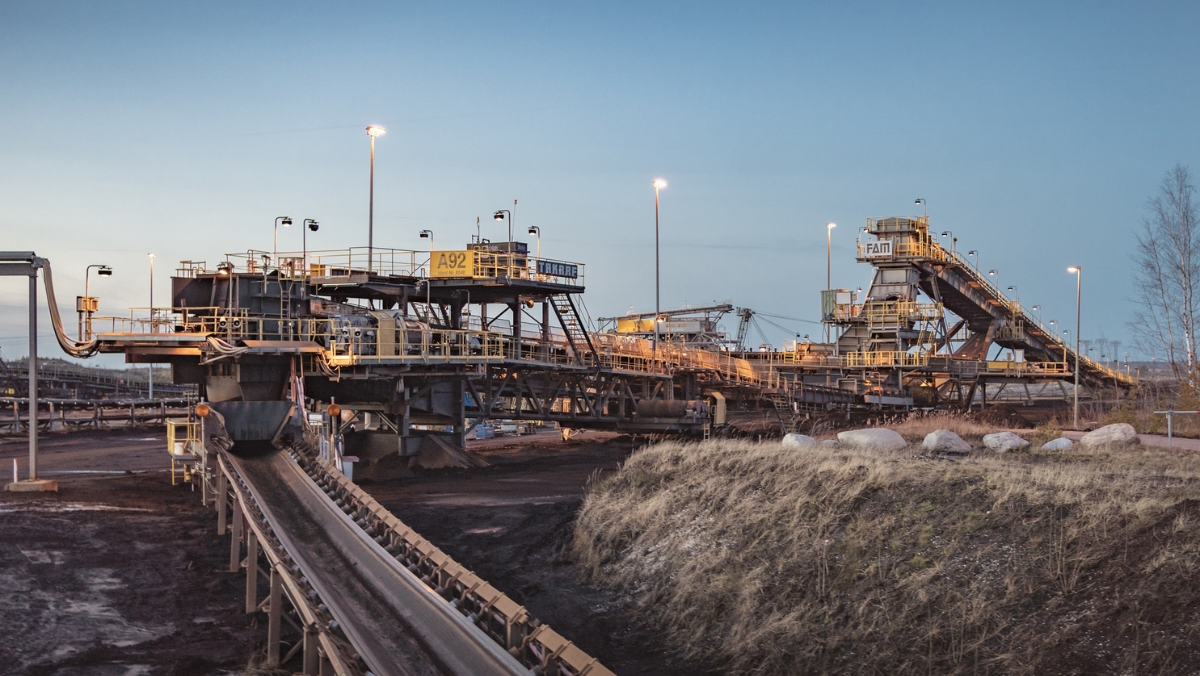 Conveyor belt systems and processing platforms under an evening sky